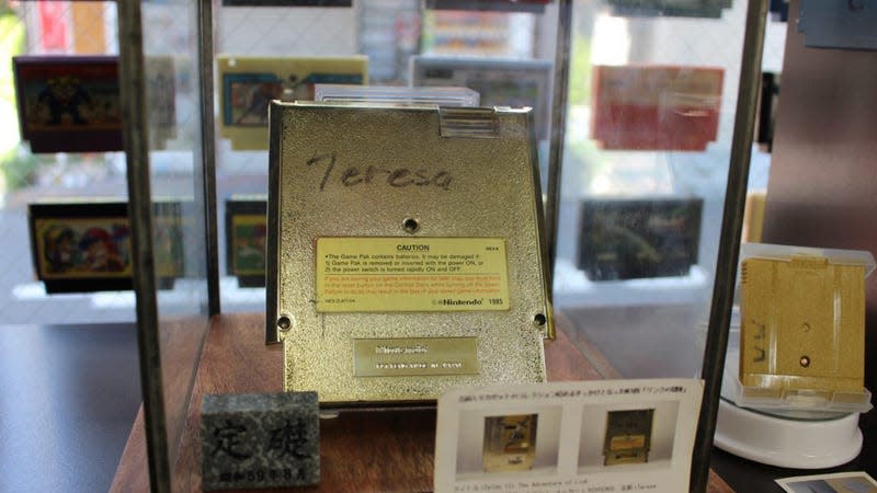A gold cartridge encased in glass shows the name Teresa written on it in marker.