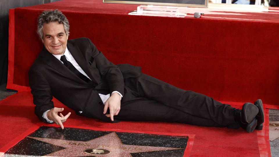 Mark Ruffalo lies down next to his star on the Hollywood Walk of Fame.  (Getty)