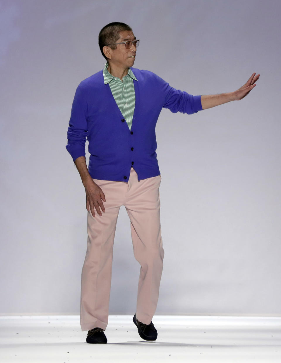 Designer Tadashi Shoji acknowledges audience applause after his Spring 2014 collection was modeled during Fashion Week in New York, Thursday, Sept. 5, 2013. (AP Photo/Richard Drew)