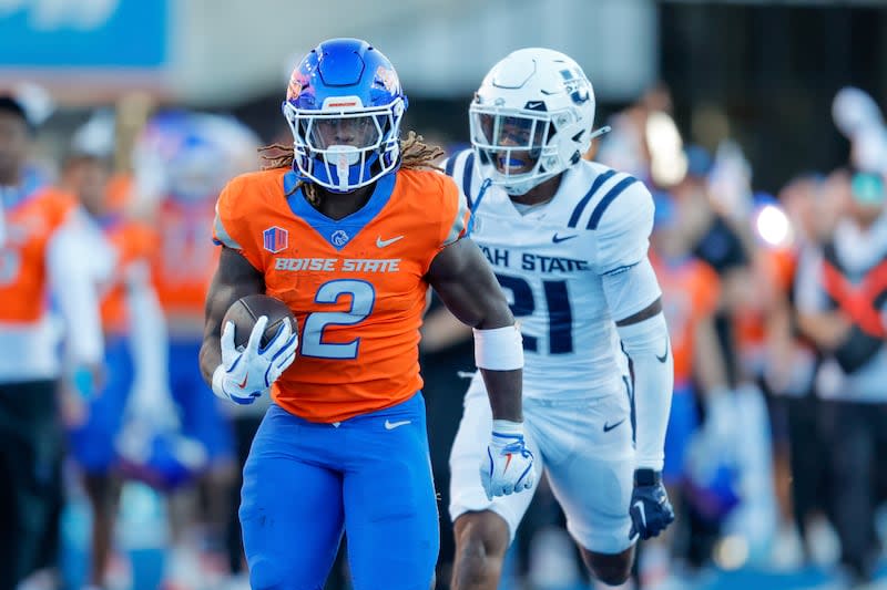 Boise State running back Ashton Jeanty (2) runs away from Utah State safety Malik McConico (21) on a 75-yard touchdown run in the first half of an NCAA college football game, Saturday, Oct. 5, 2024, in Boise, Idaho. (AP Photo/Steve Conner) | Steve Conner