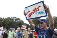 <p>Daniel Quinn of St. Petersburg holds up a sign with the phrase “It’s Mueller Time” during a rally at Demens Landing in St. Petersburg, Fla., on July 18, 2018. (Photo: Eve Edelheit/Tampa Bay Times via AP) </p>