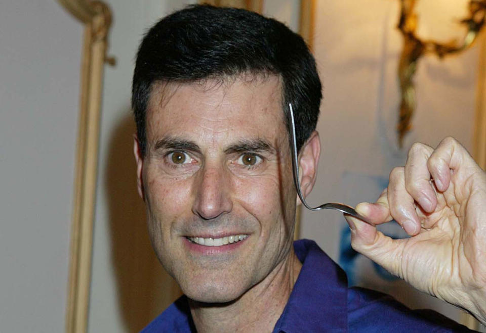 Geller pictured with his bent spoon in 2003 (PA Images)