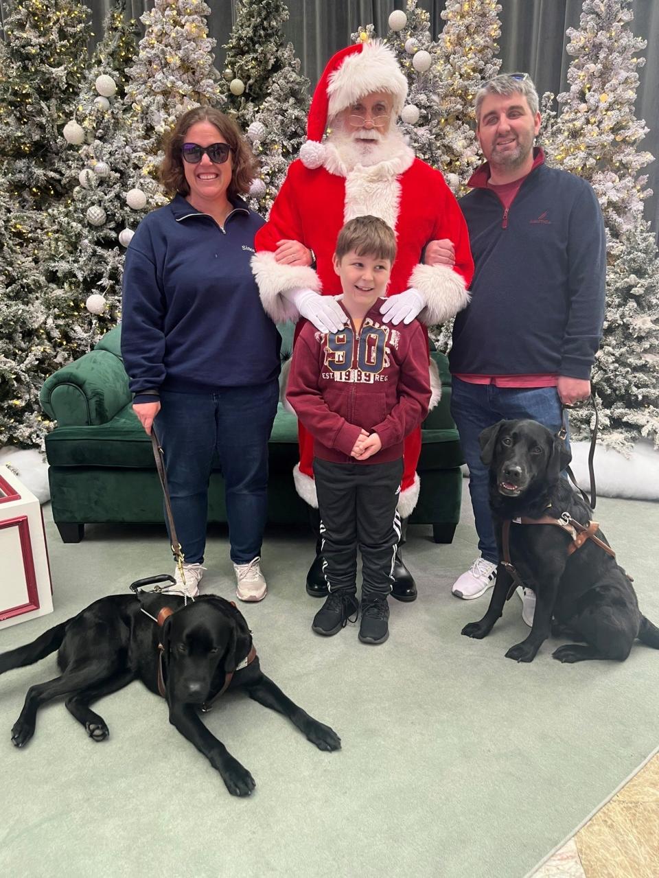 Kyle Street and his wife, Sioban Leahy, with their son, James, 8, with their guide dogs during a Christmas photo. Street and Leahy are blind and obtained their guide dogs from the Seeing Eye in Morristown.