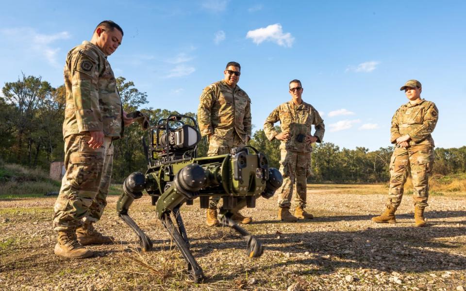 A team from the 2nd Civil Engineer Squadron monitors Atom, the robotic dog, while controlling it remotely Nov. 6, 2023, at Barksdale Air Force Base, Louisiana.