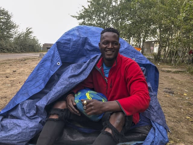 Osiama Mike outside his tent 