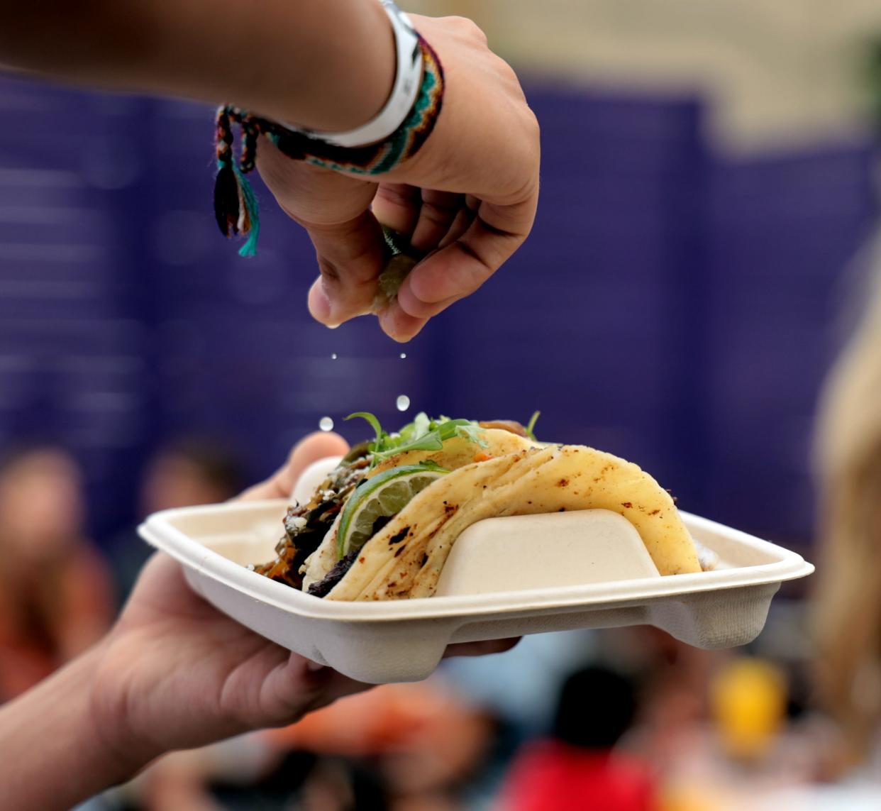Patrons sample tacos in June at VZD's carne asada taco competition.