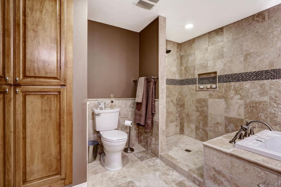 A view of brown-colored bathroom. 