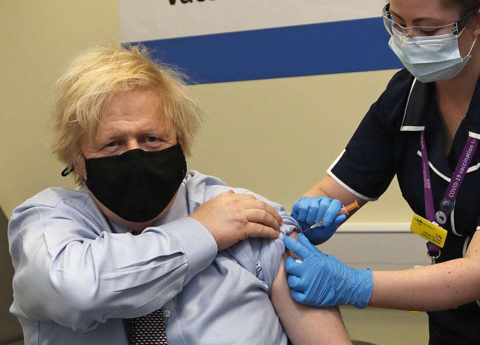 Britain's Prime Minister Boris Johnson receives the first dose of the AstraZeneca vaccine administered by nurse and Clinical Pod Lead, Lily Harrington at St. Thomas' Hospital in London, Friday, March 19, 2021. Johnson is one of several politicians across Europe, including French Prime Minister Jean Castex, getting a shot of the AstraZeneca vaccine on Friday. (AP Photo/Frank Augstein, Pool)