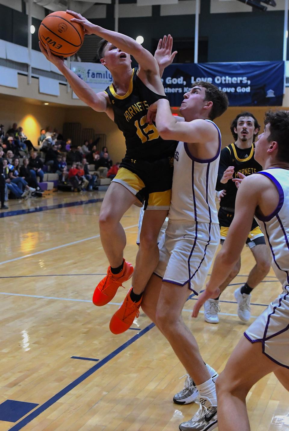 Copan High School's Tryston Easter (13) goes up against Wesleyan Christian School's Ty Cloud (12) during basketball action in Bartlesville on Jan. 26, 2024.