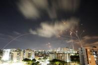 Streaks of light are seen as Israel's Iron Dome anti-missile system intercepts rockets launched from the Gaza Strip towards Israel, as seen from Ashkelon