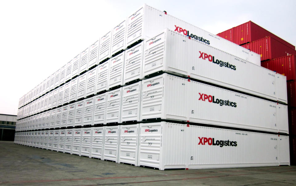 XPO-labeled containers stacked at a port.