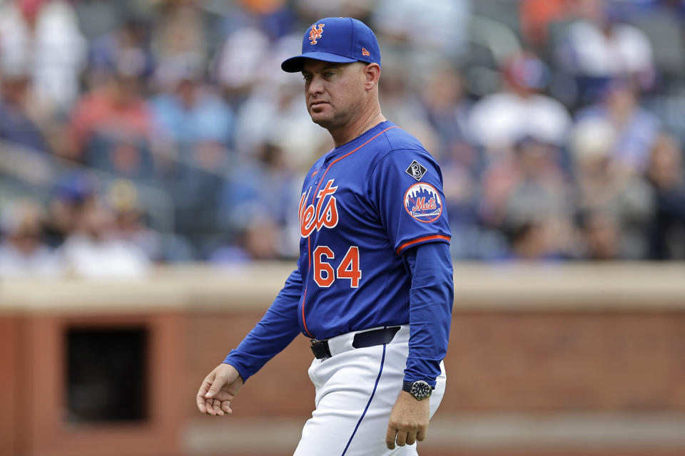 New York Mets manager Carlos Mendoza walks back to the dugout after making a pitching change in the seventh inning of a baseball game against the Philadelphia Phillies, Tuesday, May 14, 2024, in New York. (AP Photo/Adam Hunger)