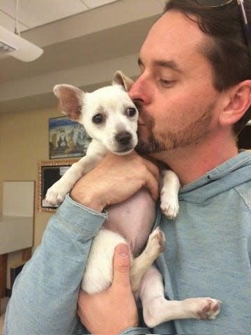 Chad Atkins, cofounder of Paw Works animal rescue, kisses squirrel the dog in 2014. Atkins, 44, died Saturday morning in Ventura.