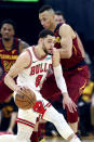 Chicago Bulls' Zach LaVine (8) drives against Cleveland Cavaliers' Dante Exum, right, in the first half of an NBA basketball game, Saturday, Jan. 25, 2020, in Cleveland. (AP Photo/Ron Schwane)