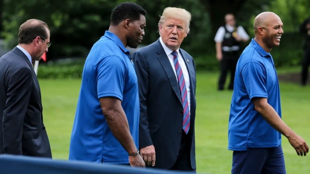 Shown in May 2018 are (from left) then-Health and Human Services Secretary Alex Azar, former NFL star Herschel Walker, then-President Donald Trump and ex-New York Yankee Mariano Rivera during the White House Sports and Fitness Day. Trump endorsed Walker for Senate in 2022. (Photo: Oliver Contreras-Pool/Getty Images)
