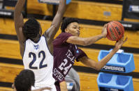 Texas Southern forward John Walker III (24) passes the ball off to a teammate after being stopped en route to the basket by Mount St. Mary's forward Nana Opoku (22) during the second half of a First Four game in the NCAA men's college basketball tournament Thursday, March 18, 2021, in Bloomington, Ind. (AP Photo/Doug McSchooler)