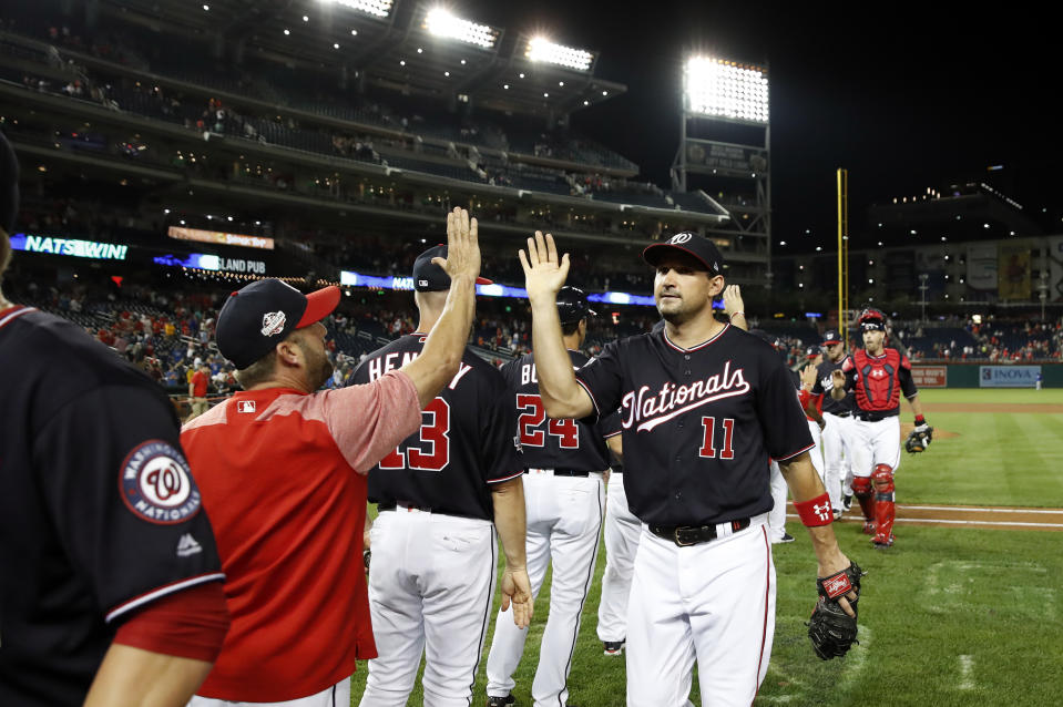 Washington Nationals' Ryan Zimmerman (11) celebrates with teammates after a baseball game against the New York Mets at Nationals Park, Tuesday, July 31, 2018, in Washington. The Nationals won 25-4. (AP Photo/Alex Brandon)