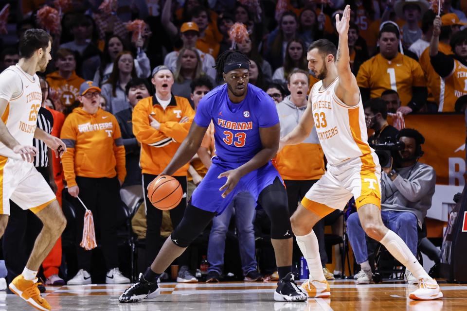 Florida center Jason Jitoboh (33) works for a shot against Tennessee forward Uros Plavsic (33) during the first half of an NCAA college basketball game Wednesday, Jan. 26, 2022, in Knoxville, Tenn. (AP Photo/Wade Payne)