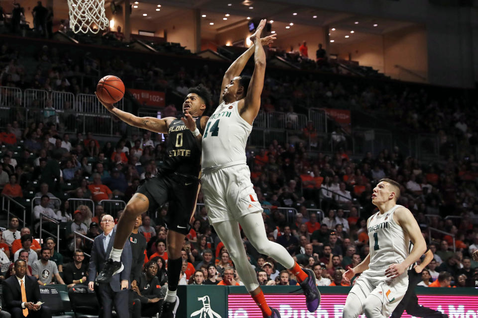 Florida State guard Rayquan Evans (0) shoots the ball against Miami center Rodney Miller Jr. (14) during the first half of an NCAA college basketball game on Saturday, Jan. 18, 2020, in Coral Gables, Fla. (AP Photo/Brynn Anderson)