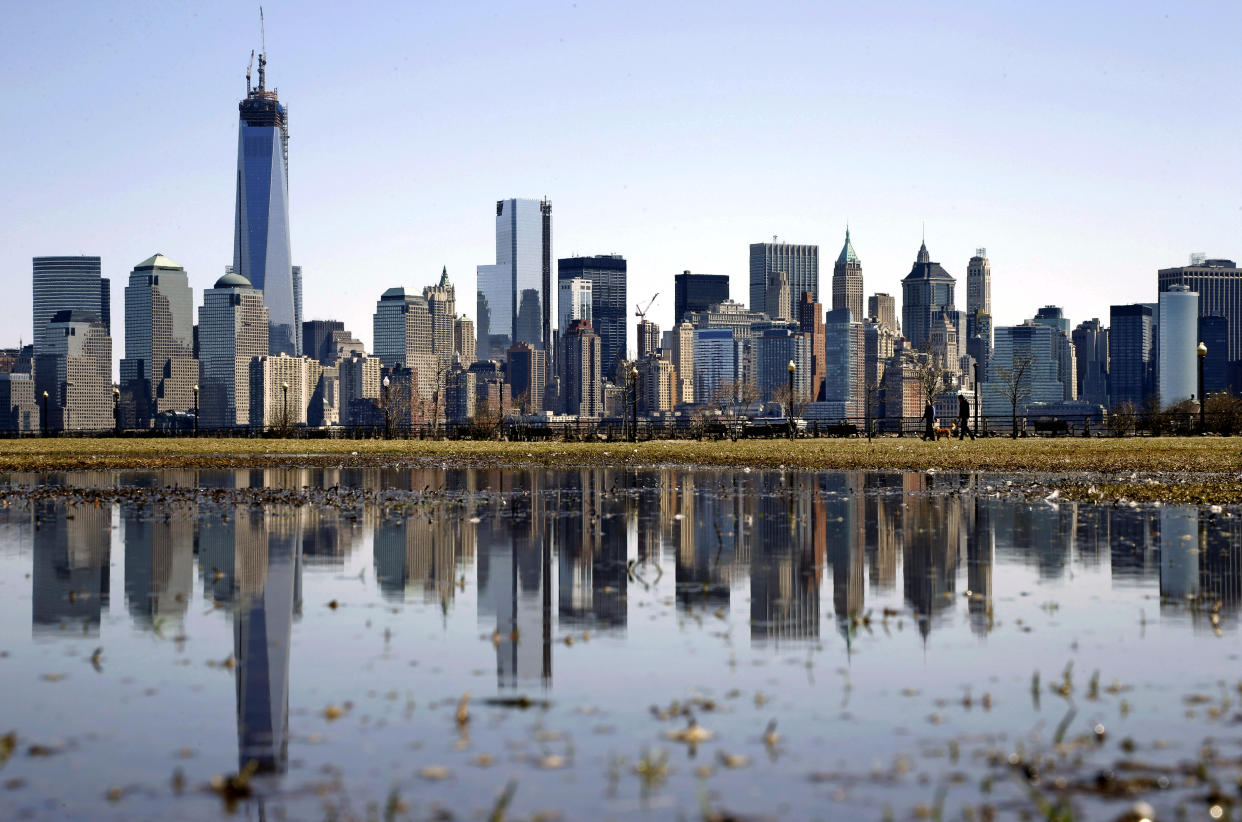 FILE - New York's Lower Manhattan skyline, including the One World Trade Center, left, is reflected in water on April 6, 2013, as seen from Liberty State Park in Jersey City, N.J. Eight of the 10 largest cities in the U.S. lost population during the first year of the pandemic, with only Phoenix and San Antonio gaining new residents from 2020 to 2021, according to new estimates released, Thursday, May 26, 2022, by the U.S. Census Bureau. (AP Photo/Mel Evans, File)