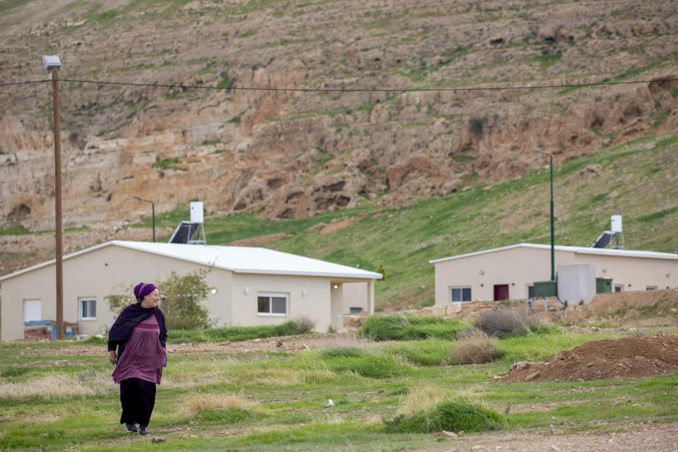 In this Monday, Feb. 10, 2020 photo, a woman walks in the Jewish settlement of Mevo'ot Yericho, in the Jordan Valley near the Palestinian city of Jericho. Israel's prime minister is eager to court the votes of the country's influential West Bank settlers in critical elections next month. President's Donald Trump's Mideast plan seemed to be the key to ramping up their support. The plan envisions Israel's eventual annexation of its scores of West Bank settlements — a long time settler dream. But in the weeks since it was unveiled, Israeli Prime Minister Benjamin Netanyahu has stumbled over his promises to quickly carry out the annexation, sparking verbal attacks from settler leaders. (AP Photo/Ariel Schalit)