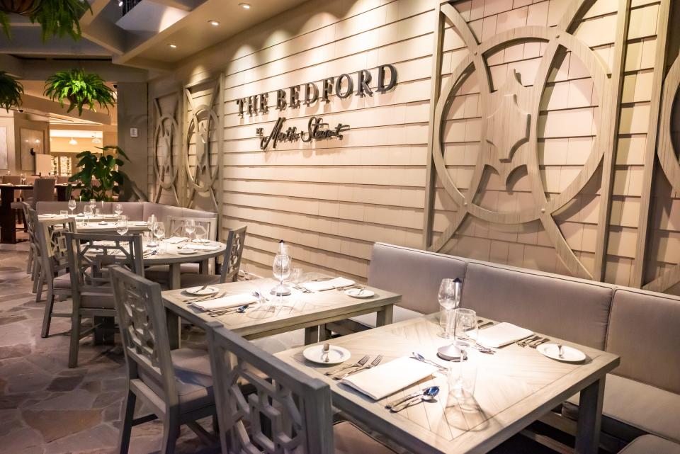 bedford interior with shiplap on the walls and light-colored booths and tables