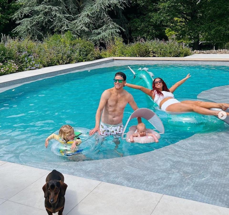 Stacey pictured in the pool with her fiancé Joe Swash and children, Rex and Rose (Instagram/Stacey Solomon)