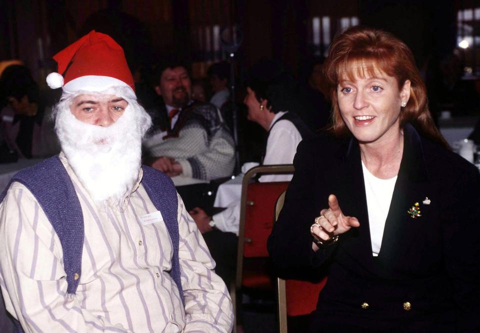 <p>Sarah Ferguson, the Duchess of York, attends a Christmas party for the Motor Neurone Disease Association, including some festively-dressed guests. </p>