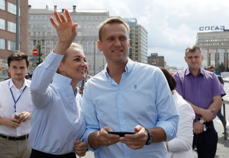 Russian opposition leader Alexei Navalny and his wife Yulia attend a rally in Moscow