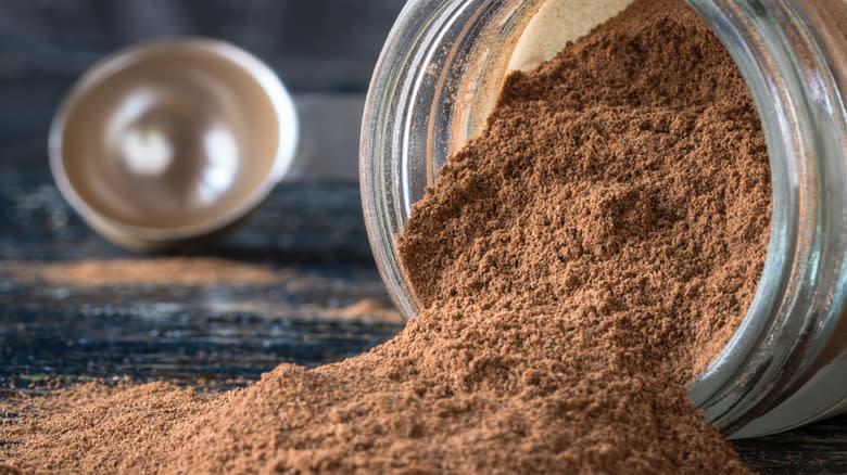 ground cinnamon spilling out of jar