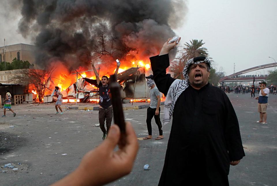 Protesters try to storm and burn the governor's building during protests demanding better public services and jobs, Tuesday, Sept. 4, 2018, in Basra, 340 miles (550 kilometers) southeast of Baghdad, Iraq. (AP Photo/Nabil al-Jurani)