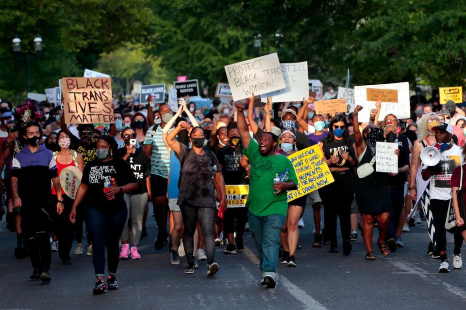 Black Lives Matter protesters held anti-racism signs as they marched down Waterman Boulevard (AP)