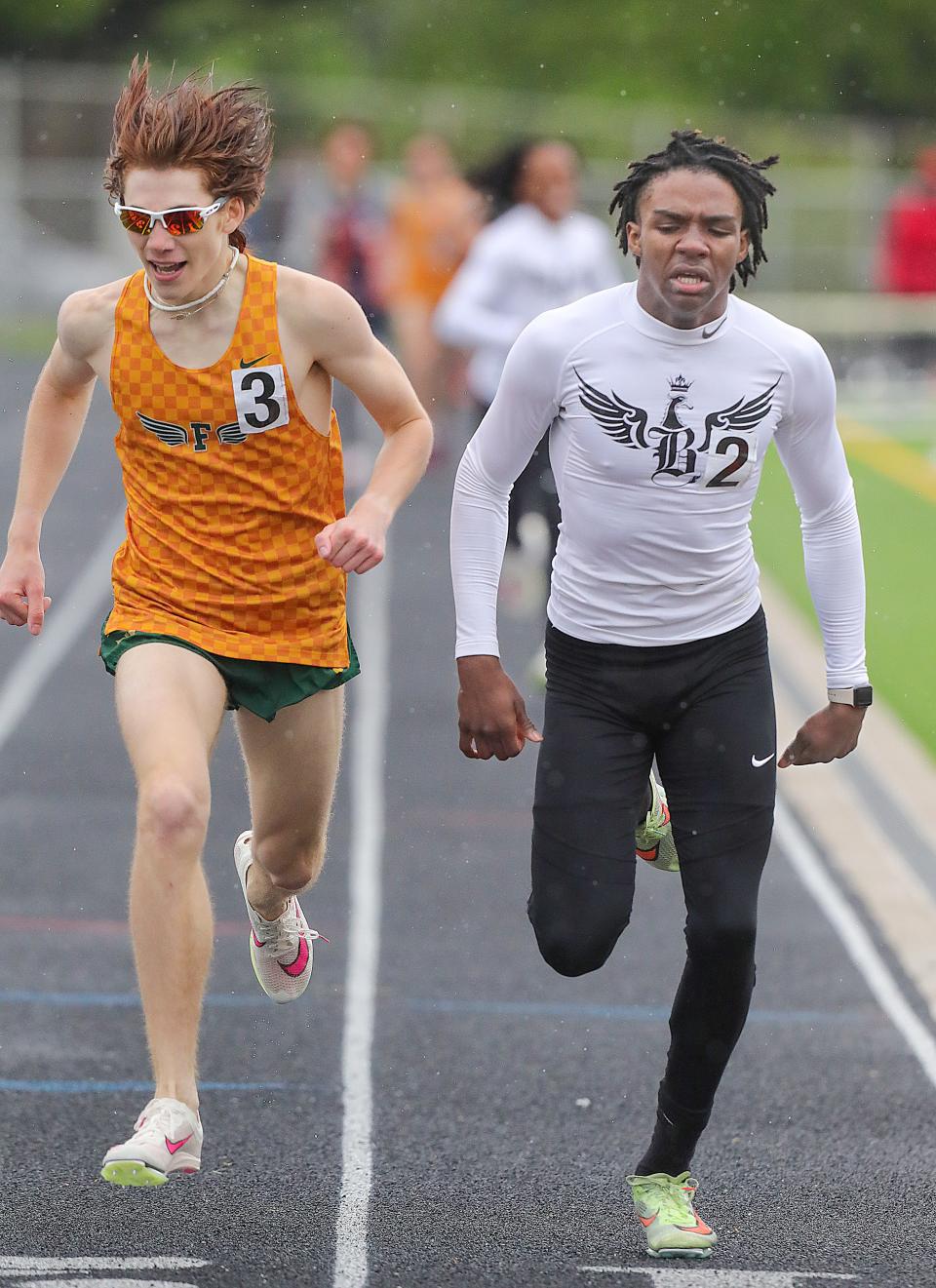 Eli Dunlap of Firestone and Dwight Shade of Buchtel during a photo finish of the 800 meters in the City Series track and field championship meet, Saturday, May 11, 2024, at Ellet High School.