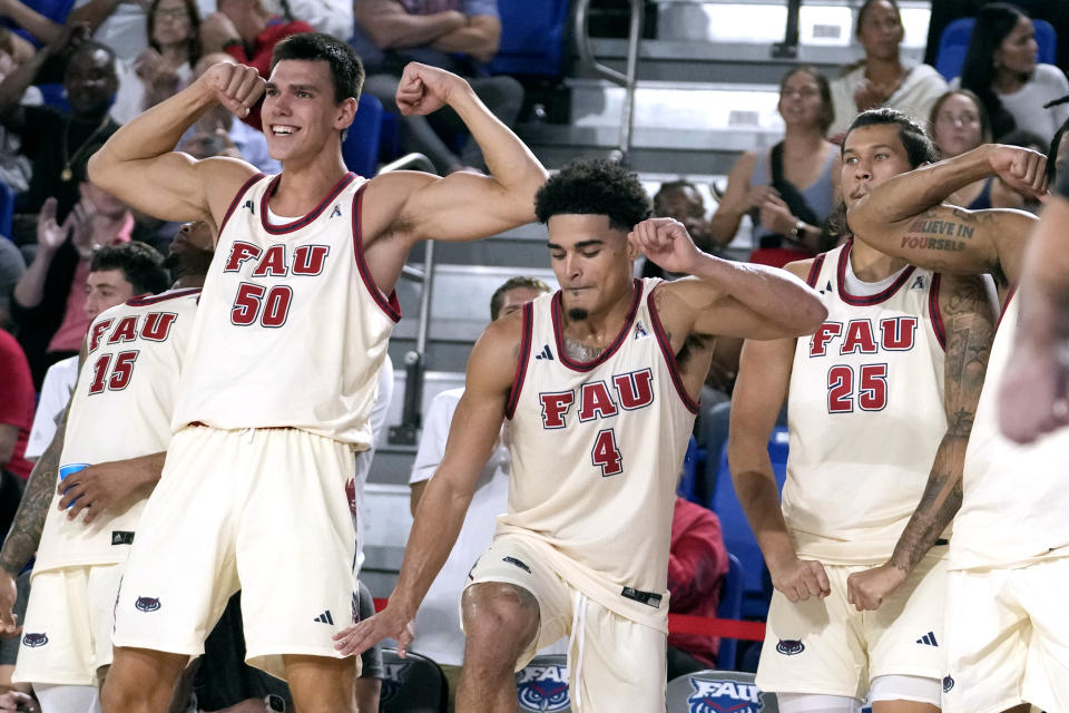 Florida Atlantic center Vladislav Goldin (50), guard Bryan Greenlee (4) and forward Tre Carroll (25) react from the bench during the second half of an NCAA college basketball game, Thursday, Nov. 30, 2023, in Boca Raton, Fla. (AP Photo/Lynne Sladky)