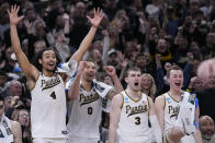 Purdue's Trey Kaufman-Renn (4) celebrates with teammates Mason Gillis (0), Braden Smith (3) and Fletcher Loyer during the second half of a second-round college basketball game against Utah State in the NCAA Tournament, Sunday, March 24, 2024 in Indianapolis. (AP Photo/Michael Conroy)