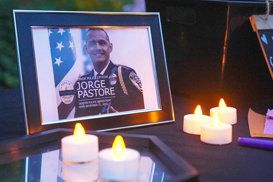 A photo of slain Austin police officer Jorge Pastore is displayed at a candlelight vigil Sunday.