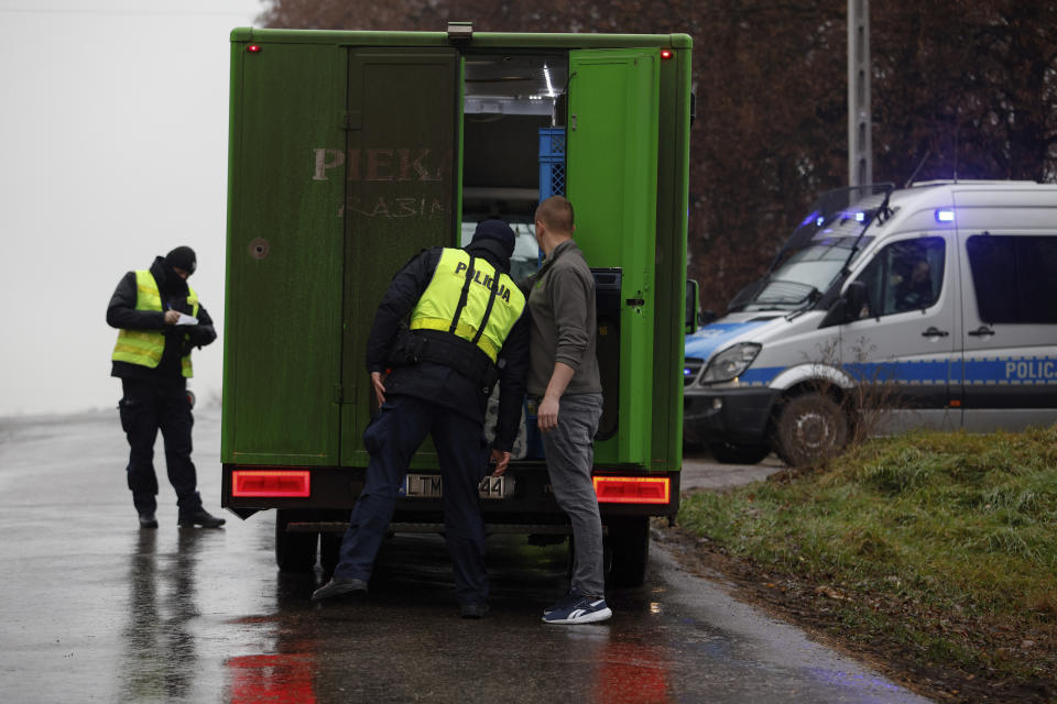A police officer checks a vehicle outside a grain depot where, according to the Polish government, an explosion of a Russian-made missile killed people, in Przewodow, Poland, Wednesday, Nov. 16, 2022. Poland said Wednesday that a Russian-made missile fell in the country’s east, killing a few people, though U.S. President Joe Biden said it was “unlikely” it was fired from Russia. (AP Photo/Michal Dyjuk)