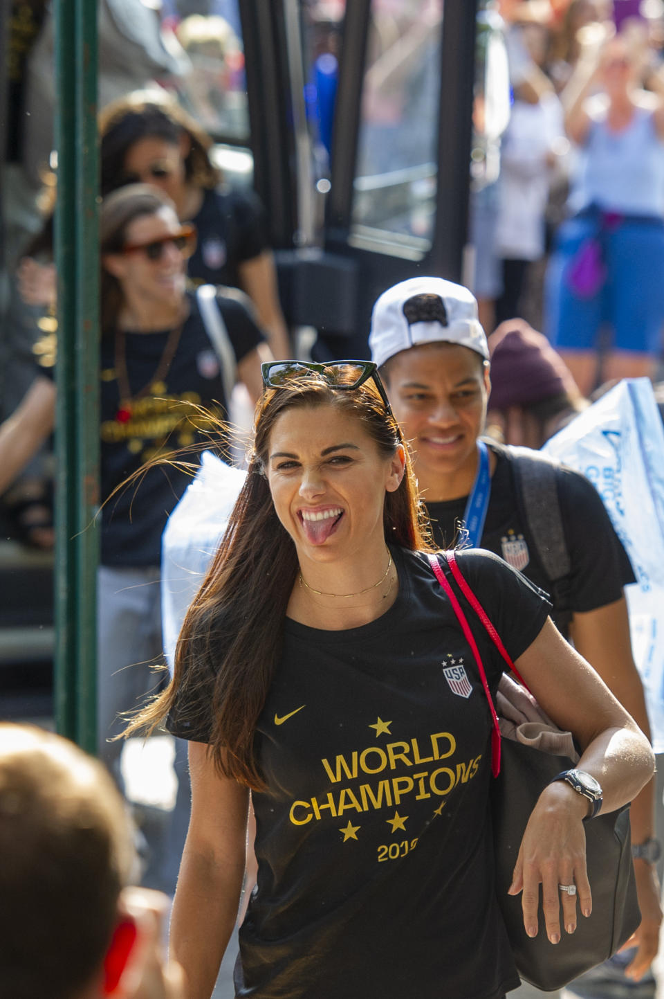 United States women's soccer team member Alex Morgan, foreground, sticks out her tongue as teammate Crystal Dunn follows her Monday, July 8, 2019, in New York. The city will honor the team with a parade Wednesday for their fourth Women's World Cup victory. (AP Photo/Corey Sipkin)