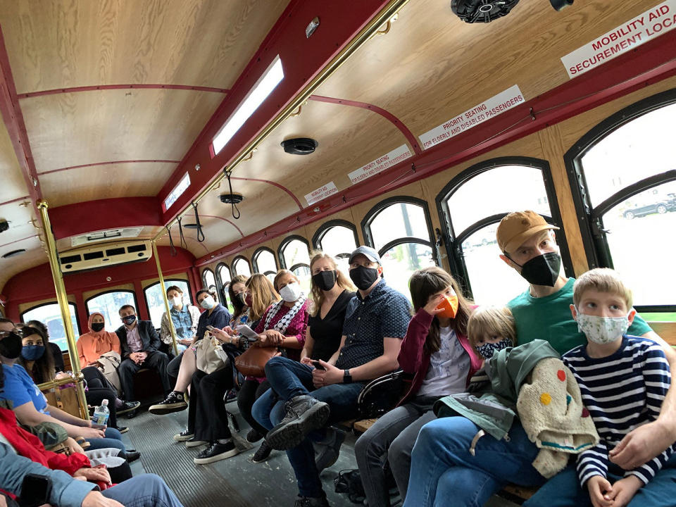 Chicago Interfaith Trolley Tour attendees ride between stops April 24, 2022, in Chicago. The tour, which took place on Orthodox Easter, was inspired by the convergence of Muslim, Jewish, Christian, Hindu, Jain, Sikh and Baha’i holidays in April. It was a chance to promote interfaith understanding, said organizers. (Bob Smietana/RNS via AP)