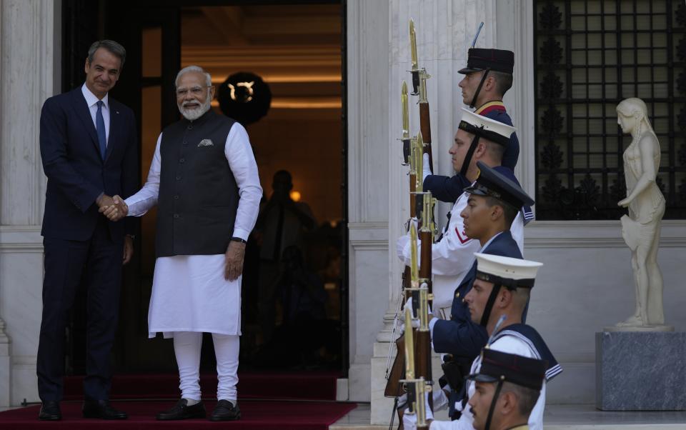 Greece's Prime Minister Kyriakos Mitsotakis, left, welcomes, his Indian counterpart Narendra Modi at Maximos Mansion in Athens, Greece, Friday, Aug. 25, 2023. Modi's visit to Athens is especially significant for Greek foreign policy as it is the first official visit by an Indian prime minister to Greece in 40 years. (AP Photo/Thanassis Stavrakis)