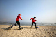 Special olympics athletes Esraa Gamal and Alaa Abdelaziz train with snowshoes on a beach in Alexandria. The four-member snowshoe team of two men and two women with learning disabilities had never seen snow before arriving in Austria for the tournament in March, but they were prepared: winning gold in the relay as well as individual medals. REUTERS/Mohamed Abd El Ghany