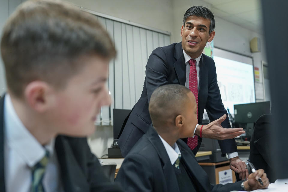 FILE - Britain's Prime Minister Rishi Sunak meets students taking part in a personal development lesson as he visits Haughton Academy to outline plans for the banning of single use vapes, in Darlington, England, on Jan. 29, 2024. British lawmakers will on Tuesday April 16, 2024 debate and vote on the government's plans to introduce a landmark smoking ban that aims to stop young people from ever smoking. (Ian Forsyth/Pool Photo via AP, File)