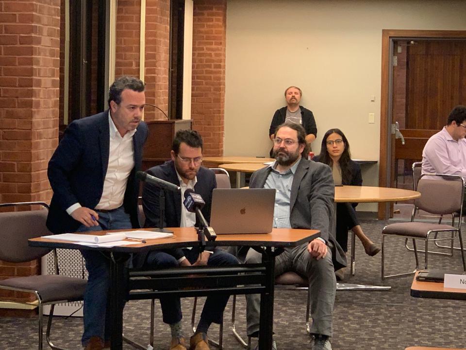 Attorney Dylan Conley addresses the Providence City Plan Commission about Dustin Dezube's (right) proposed mixed-use complex on Wickenden Street. Architect Kevin Diamond (center) managed to hide a fifth story of the building from view on Brook Street.