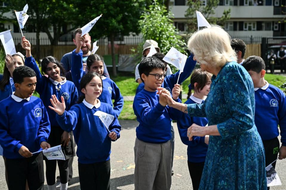 Queen Camilla  is greeted by pupils in the courtyard of the school (Justin Tallis/PA Wire)