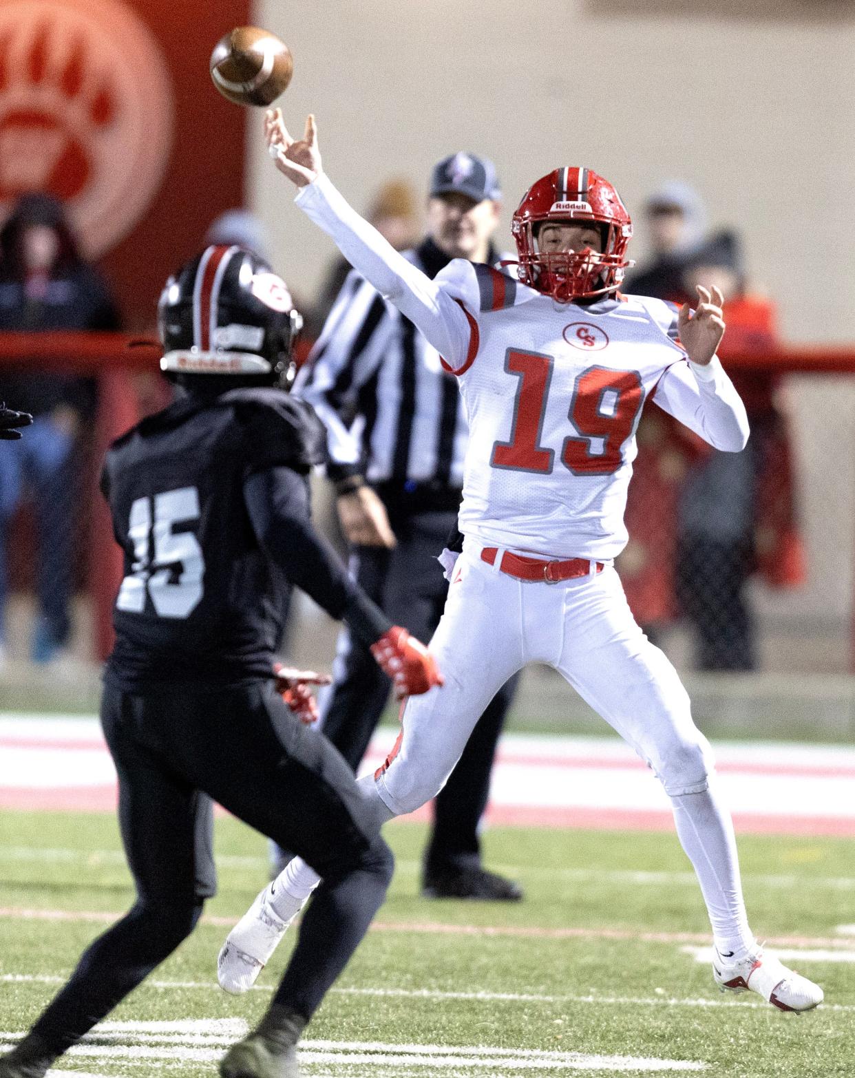 Canton South quarterback Poochie Snyder gets a pass off over Glenville defender Calvet Dessau in the first half during their Div. 4 OHSAA high school football playoff game at Wadsworth High School Friday, November 24, 2023.