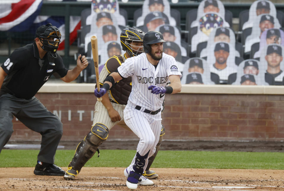 Colorado Rockies' David Dahl, front, breaks from the batter's box after hitting a single next to San Diego Padres catcher Francisco Mejia during the second inning of a baseball game Saturday, Aug. 1, 2020, in Denver. (AP Photo/David Zalubowski)