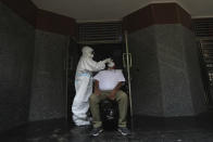 A health worker takes nasal swab sample for covid-19 test in New Delhi, India, Monday, Sept. 7, 2020. India's coronavirus cases are now the second-highest in the world and only behind the United States, as the caseload crosses Brazil on a day when urban metro trains partially resume service in the capital New Delhi and other states. (AP Photo/Manish Swarup)