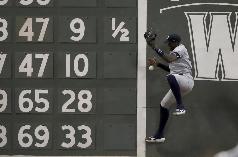 New York Yankees left fielder Cameron Maybin jumps but can't make the play on an RBI double off the wall by Boston Red Sox's Sam Travis in the seventh inning of a baseball game at Fenway Park, Friday, July 26, 2019, in Boston. (AP Photo/Elise Amendola)