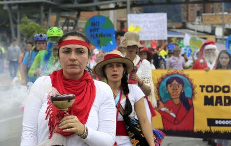 Women activists take part in a march ahead of the 2015 Paris Climate Change Conference, known as the COP21 summit, in Bogota, Colombia November 29, 2015. REUTERS/Jose Miguel Gomeza