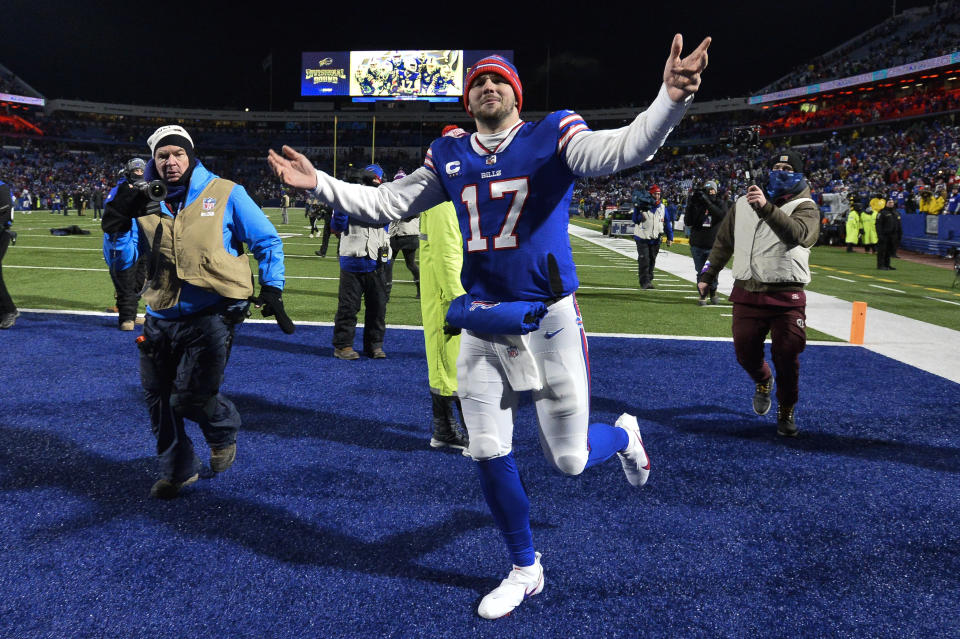 Buffalo Bills quarterback Josh Allen (17) celebrates as he runs off the field after an NFL wild-card playoff football game against the New England Patriots, Saturday, Jan. 15, 2022, in Orchard Park, N.Y. (AP Photo/Adrian Kraus)